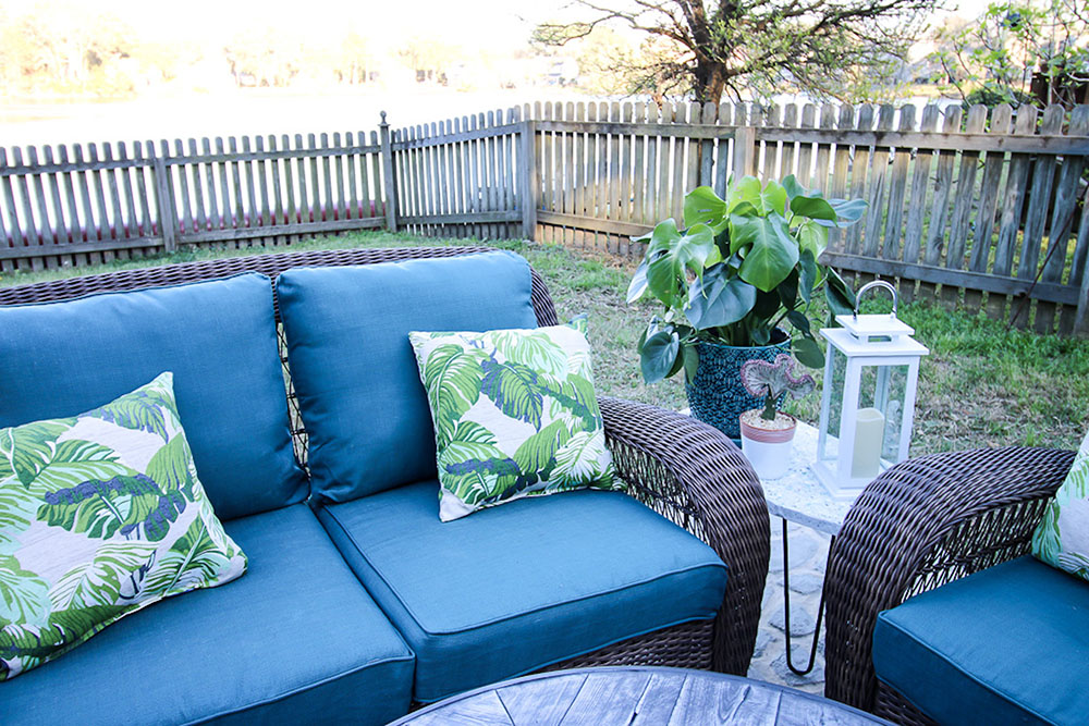 A decorated patio inside a fenced in backyard. A decorated patio inside a fenced in backyard.