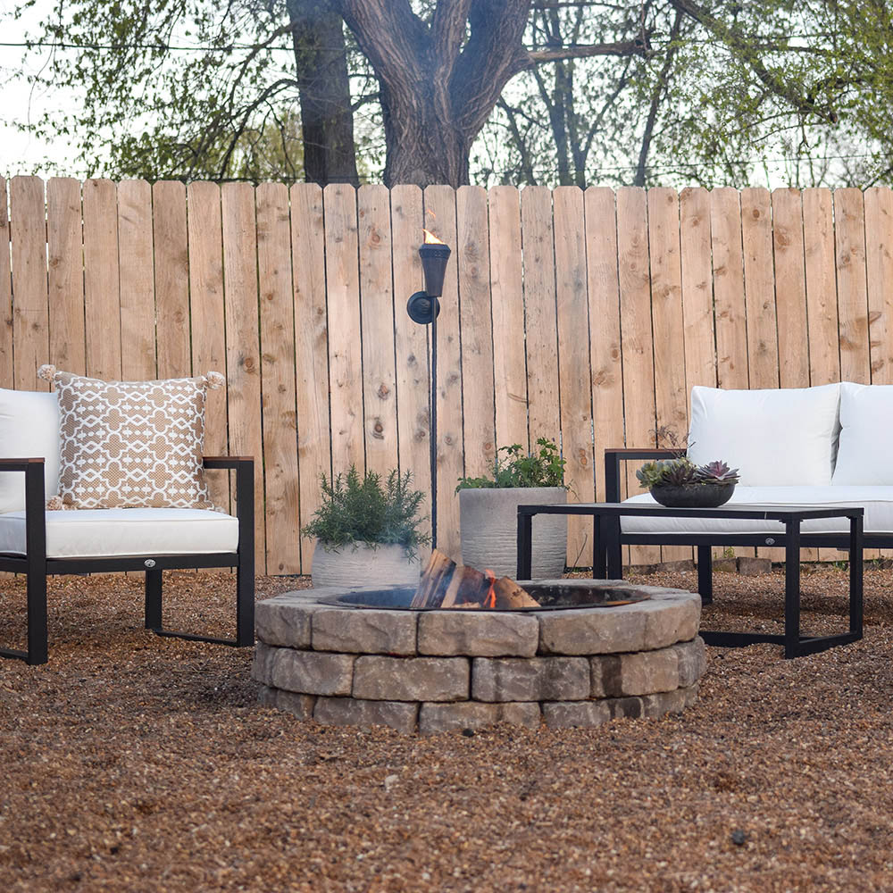 A modern outdoor seating area in front of fire pit.