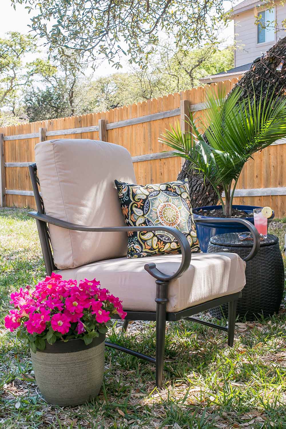 A medallion throw pillow sits in an outdoor chair. A medallion throw pillow sits in an outdoor chair.