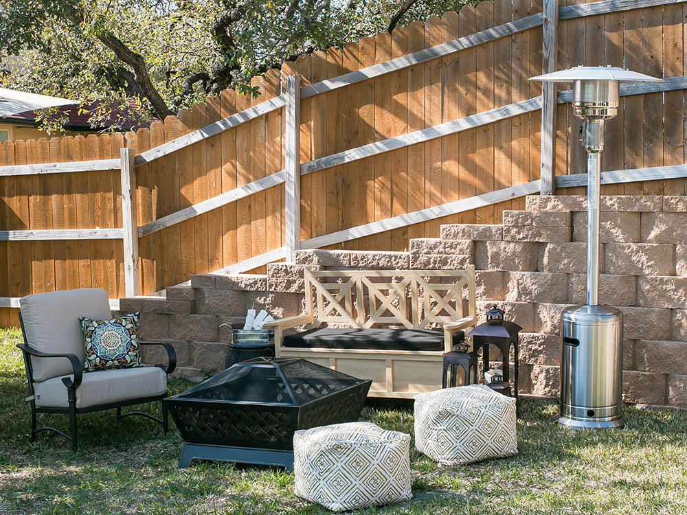 An outdoor space with a fire pit and patio heater. An outdoor space with a fire pit and patio heater.