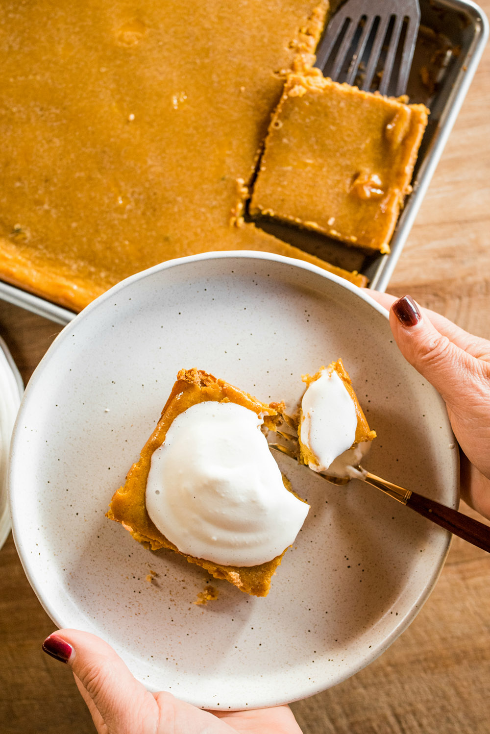 A pumpkin pie square on a plate.