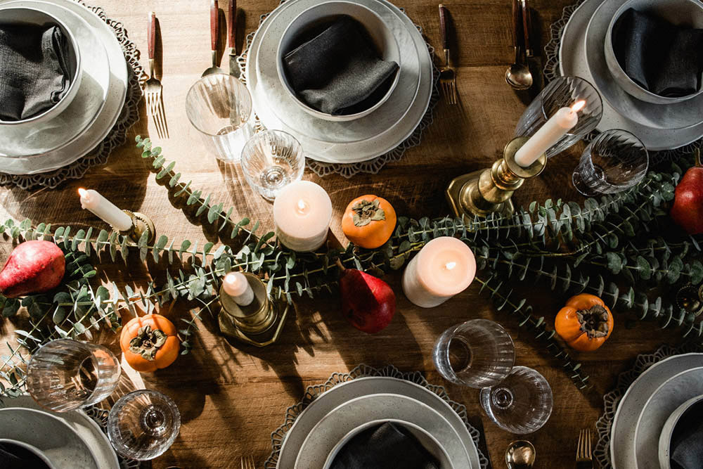 A dining table decorated for a Friendsgiving dinner.