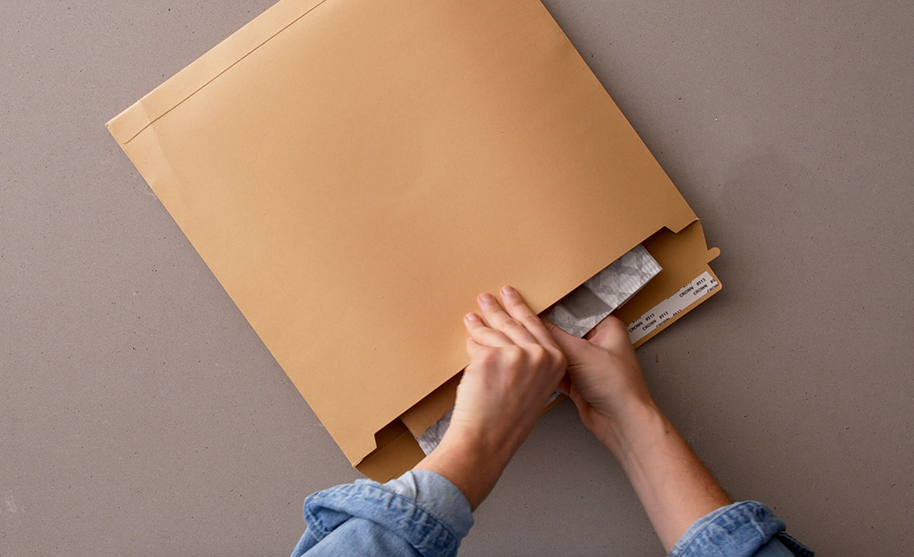 A wrapped DIY pouch is placed in a shipping envelope. A wrapped DIY pouch is placed in a shipping envelope.