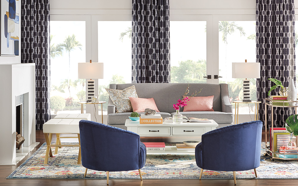 A living room with patterned curtains hanging over the window.