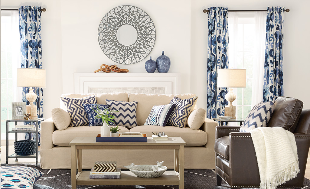 Blue and white patterned curtains over the windows in a living room.