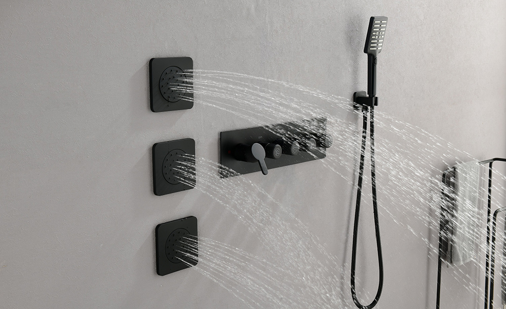 Black shower jets with water shooting out.