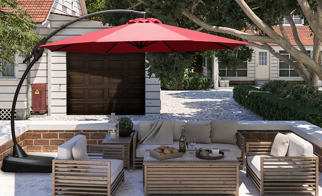A patio living area covered by an umbrella patio shade.