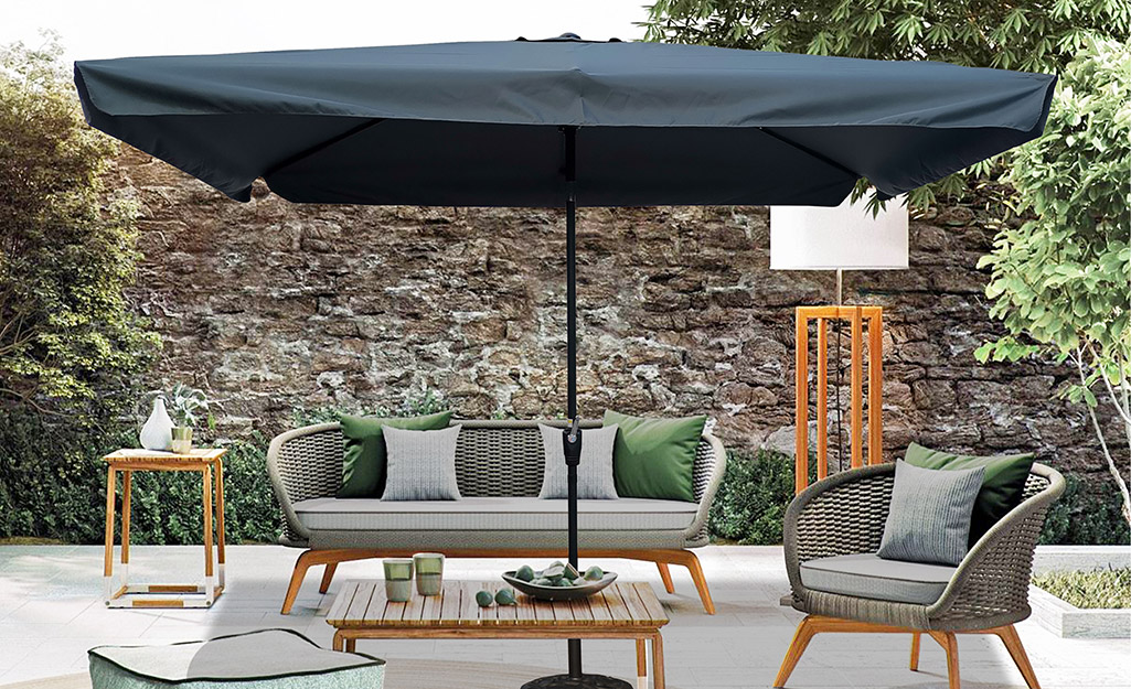 An outdoor patio covered by a pop up umbrella shade.