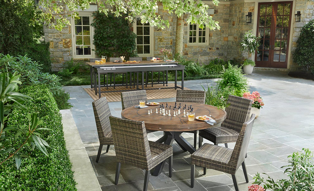 Trees shade a dining area on a patio.