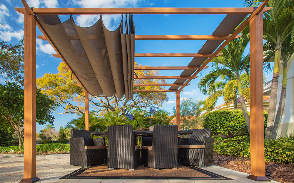 A pergola with an adjustable top cover for shade.