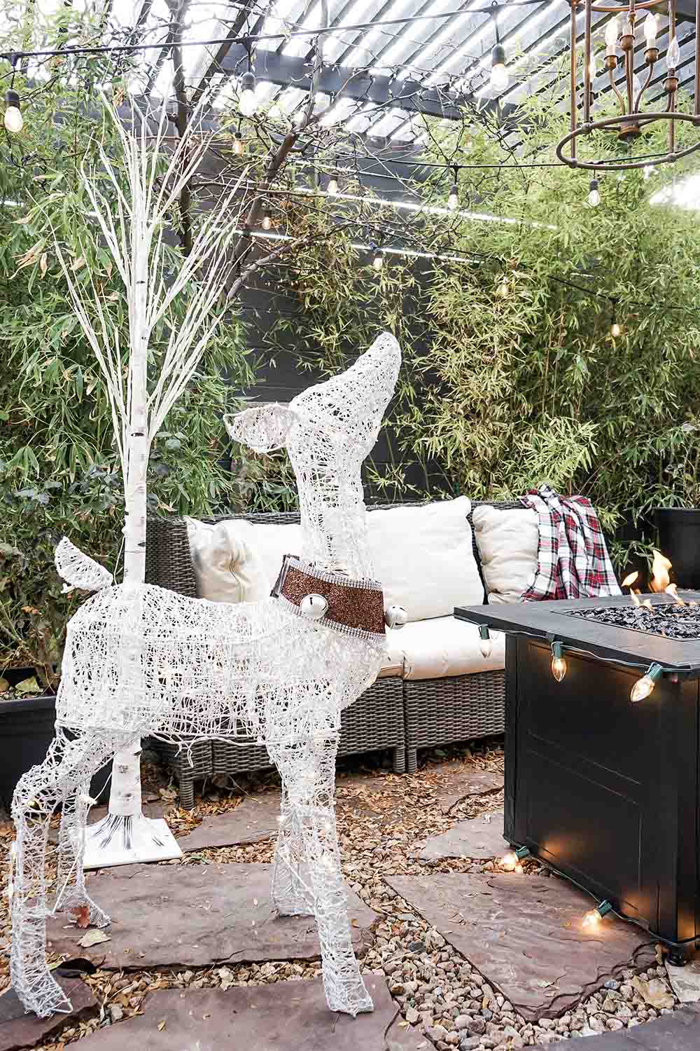 An LED white lighted deer with a collar.