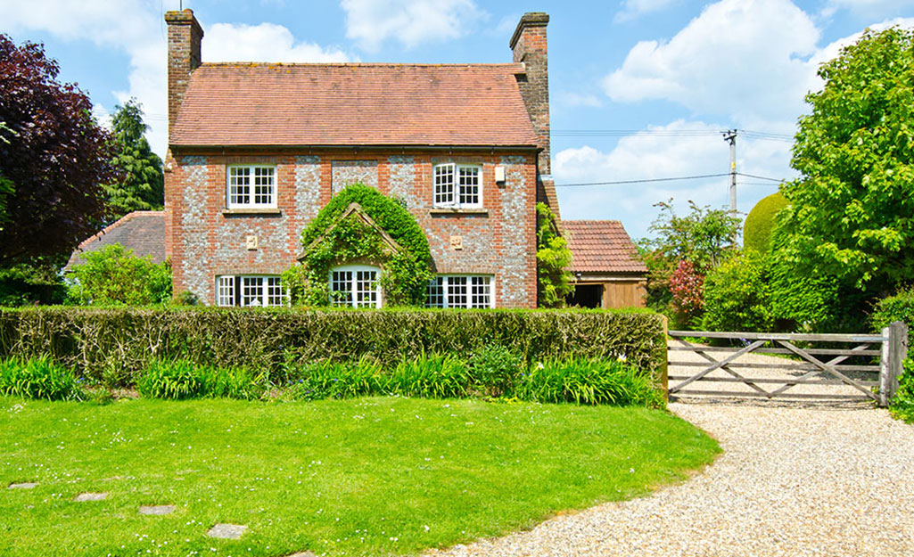 A home with a curved gravel driveway.