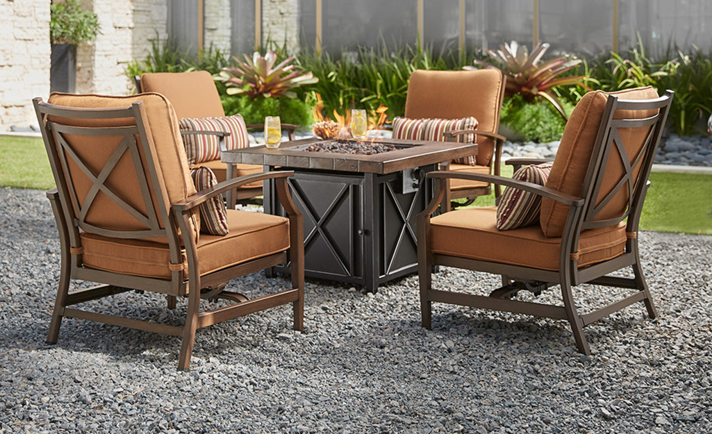 A set of garden furniture on an outdoor gravel surface.