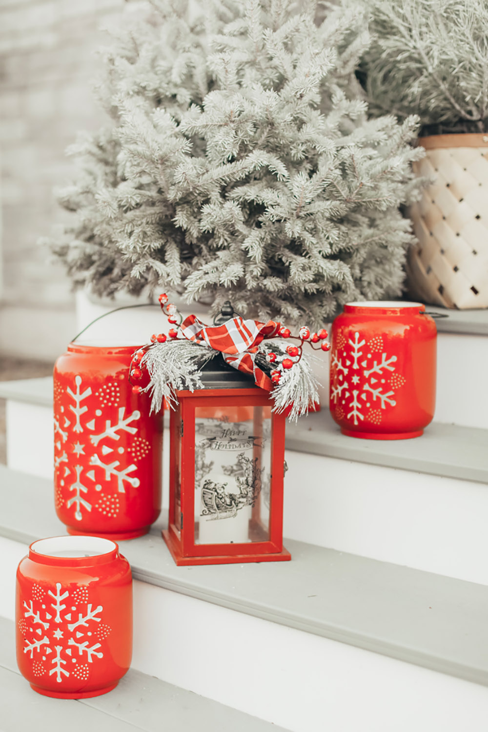 Lanterns and small Christmas trees on front porch steps Lanterns and small Christmas trees on front porch steps