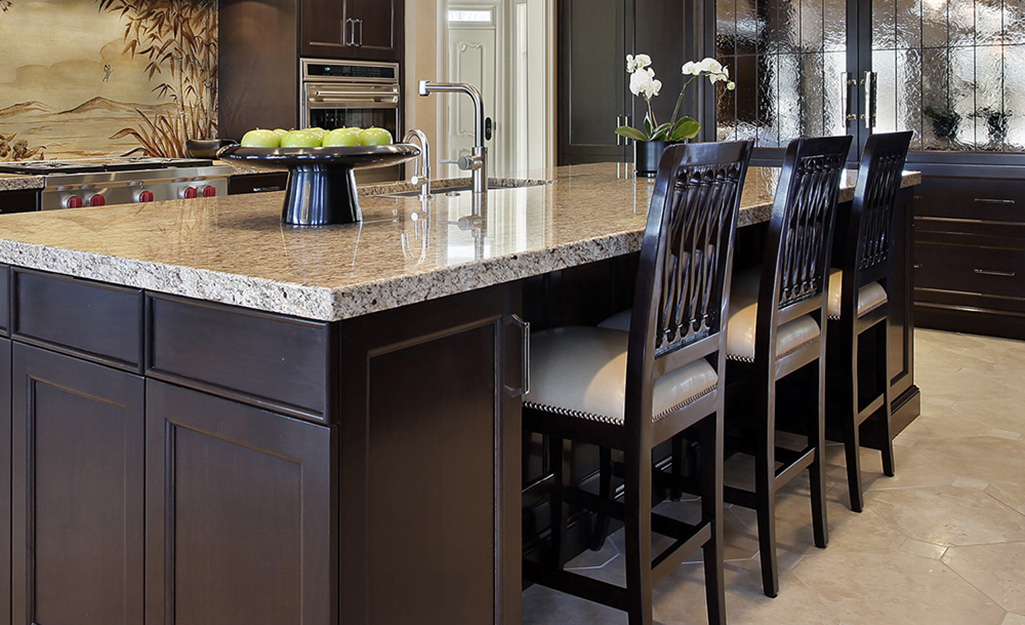 A kitchen island with dining table addition and dining chairs.