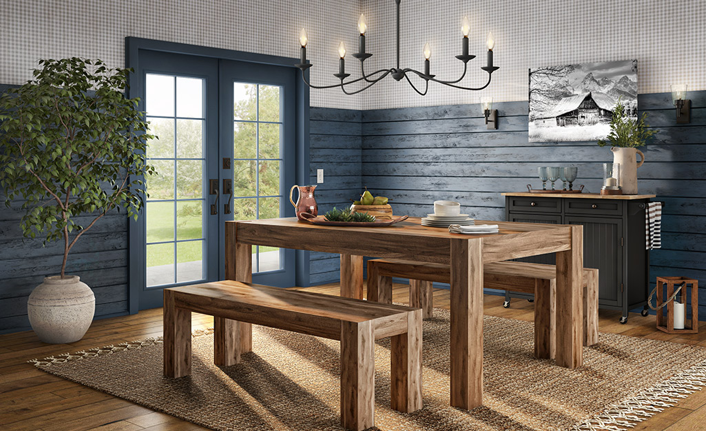 Wooden bench-style dining room set is set of by dramatic wall texture and wall art.