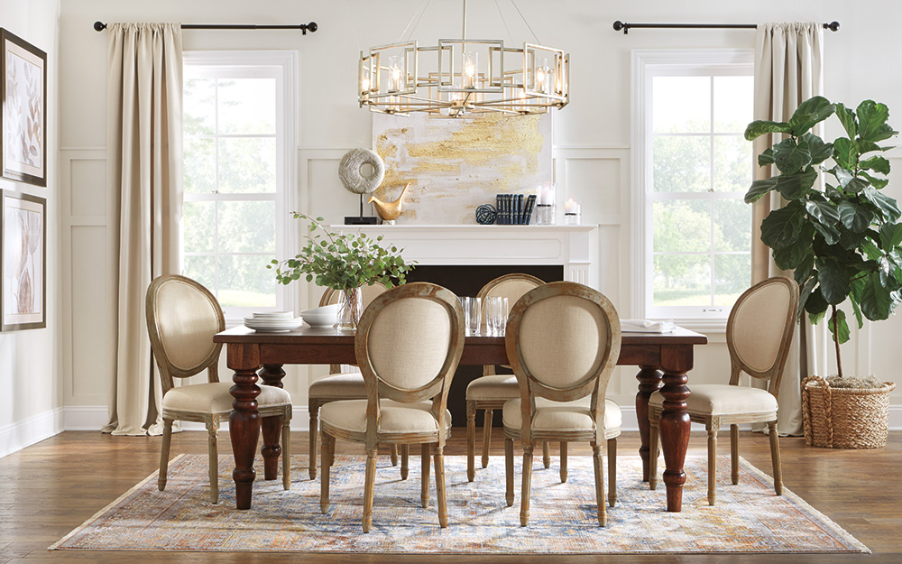 luxury dining room with circle back dining chairs and a gold chandelier 