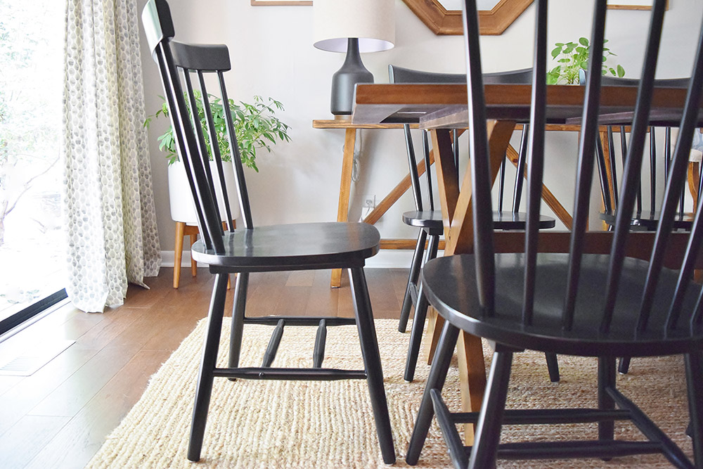 Black dining room chairs under dining table
