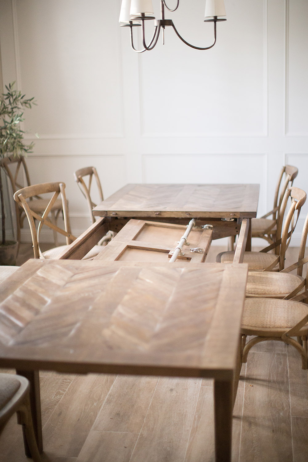 A large parquetry French gray extendable dining table. A large parquetry French gray extendable dining table.