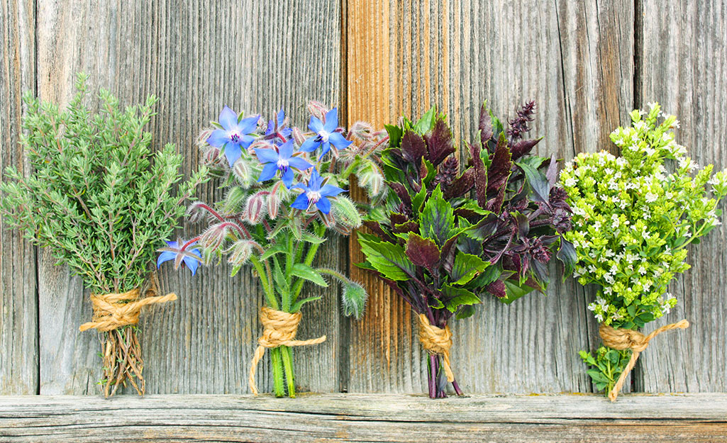 Four bouquets of flowers side by side on a wooden background