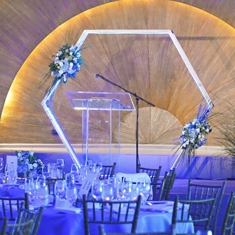 A wedding reception decorated with a DIY hexagon backdrop.