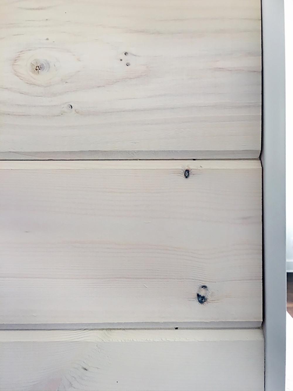 The edge of several installed beachwood boards with trim added to them. The edge of several installed beachwood boards with trim added to them.