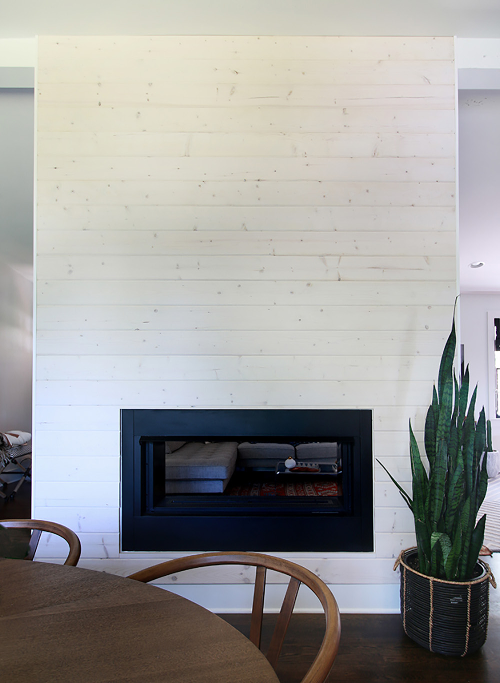 The completed DIY modern shiplap fireplace built with beachwood boards. The completed DIY modern shiplap fireplace built with beachwood boards.