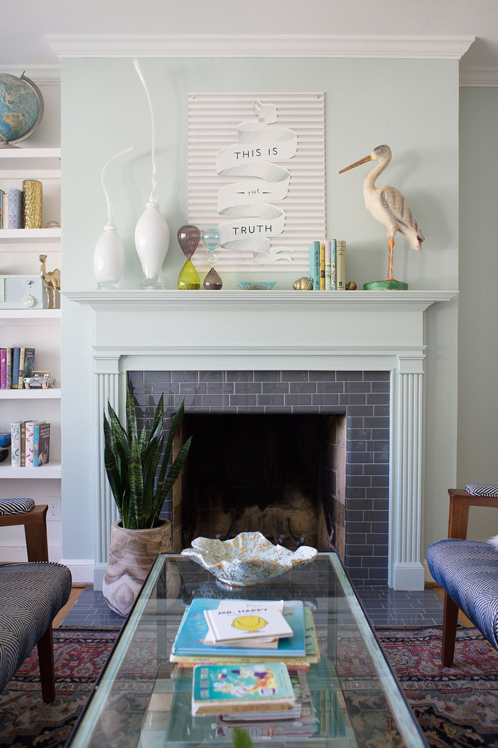 A fireplace tiled with gray Smart Tiles.