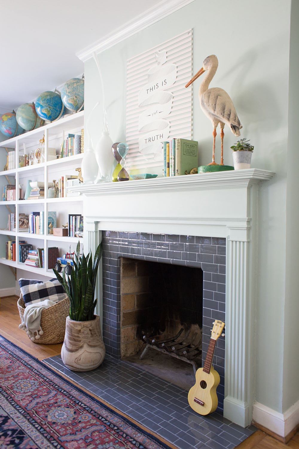 An fireplace updated with gray peel and stick tiles.