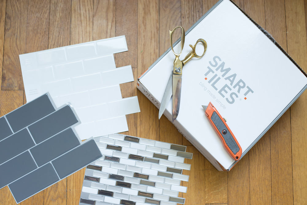A box of Smart Tiles, scissors, and a utility knife.