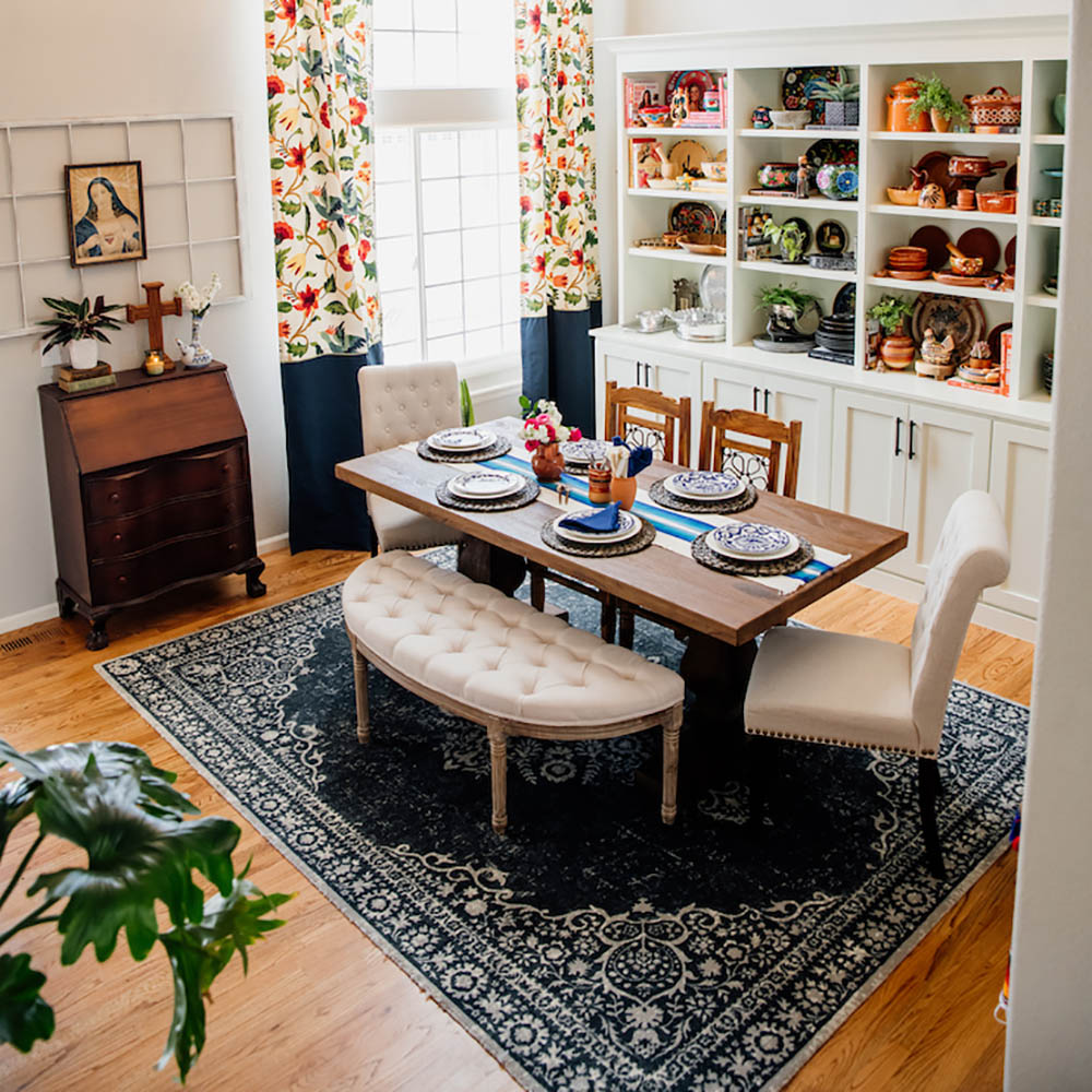 A dining room with white built-in bookshelves.