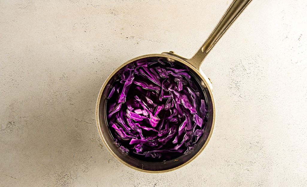 A pot with shredded cabbage in it. A pot with shredded cabbage in it.