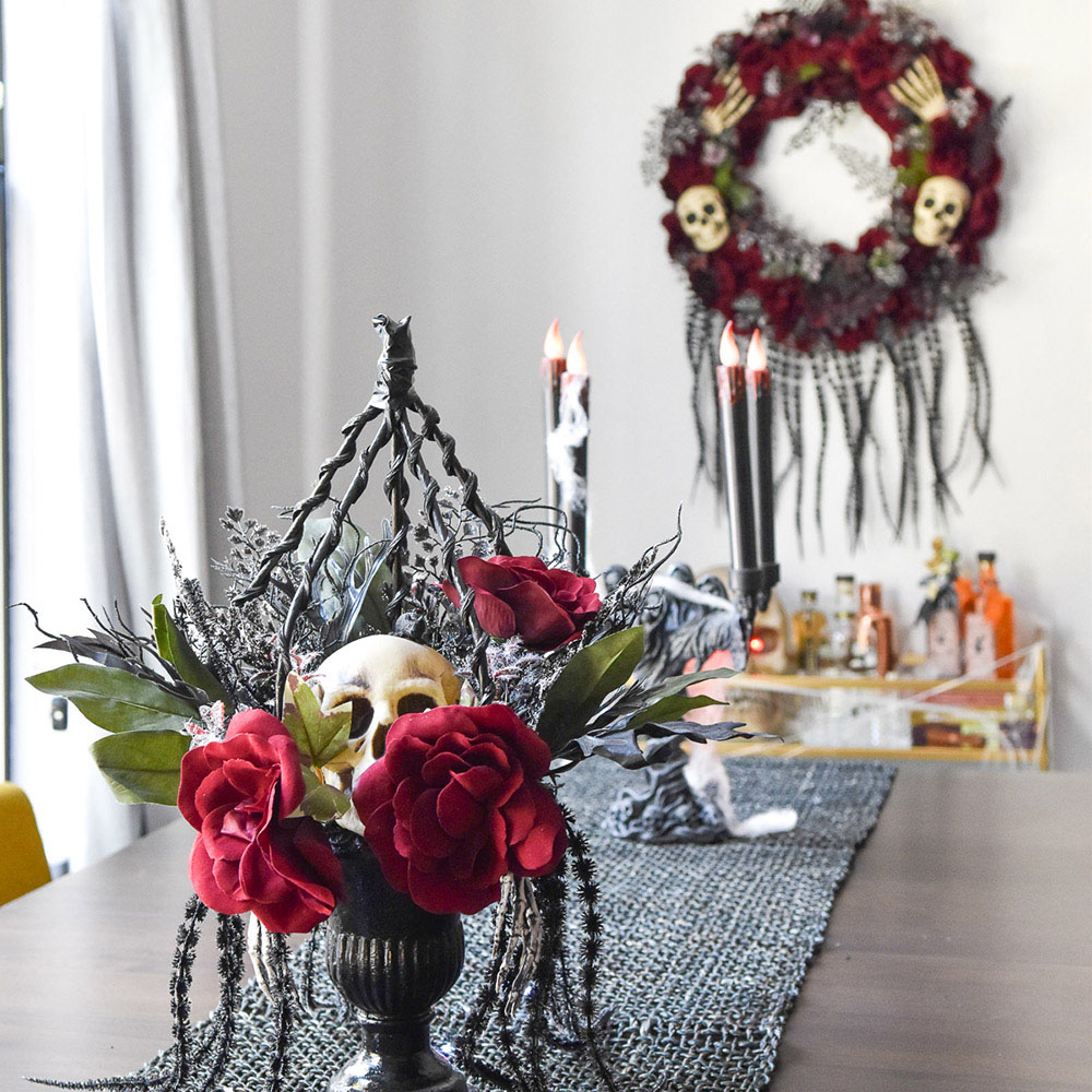 A dining room decorated in red and black with skull accents for Halloween.