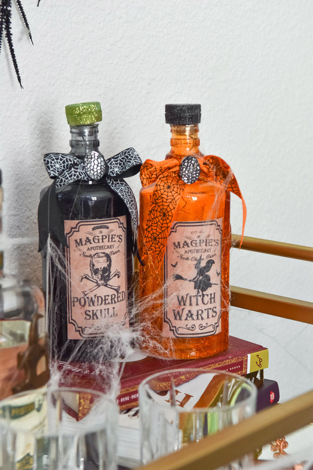 A beverage cart decorated with Halloween crackle glass bottles.