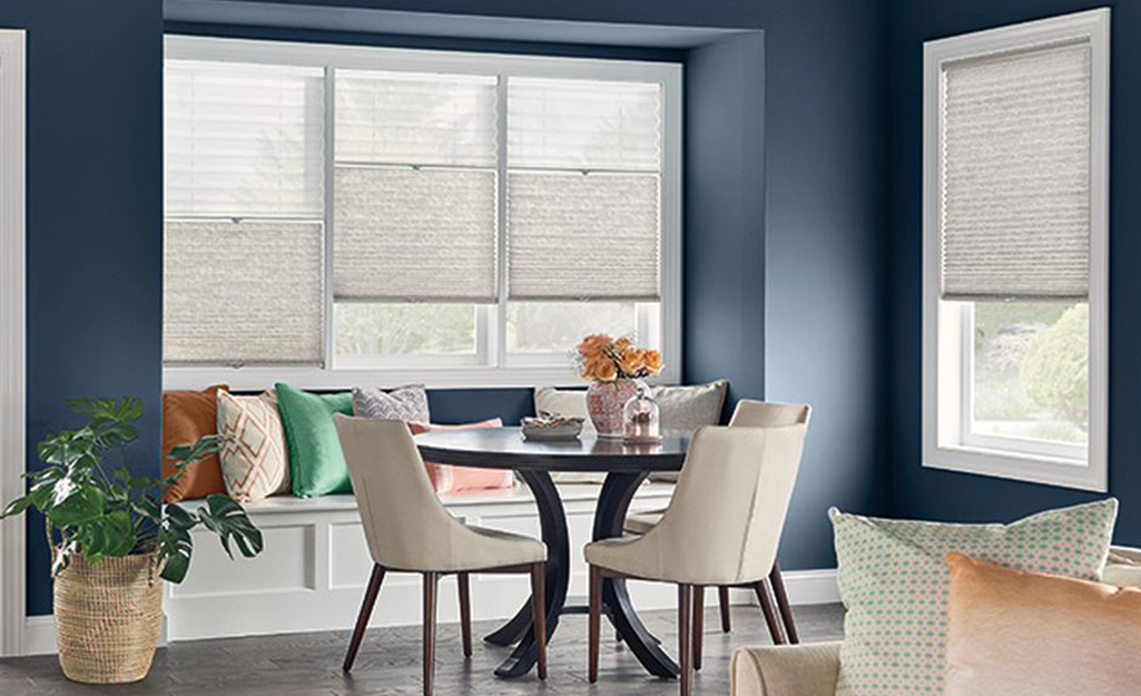 A breakfast nook with Trilight cellular shades on the windows.