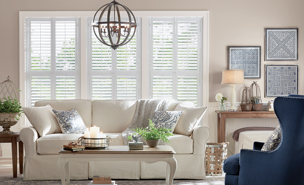 A living room with interior plantation shutters on the windows.