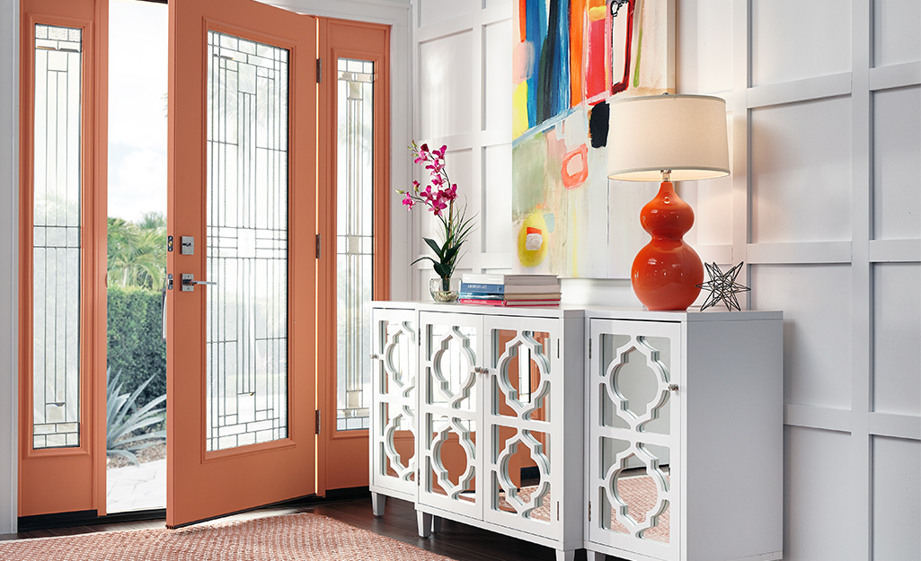 Mirrored door credenza placed near front door.