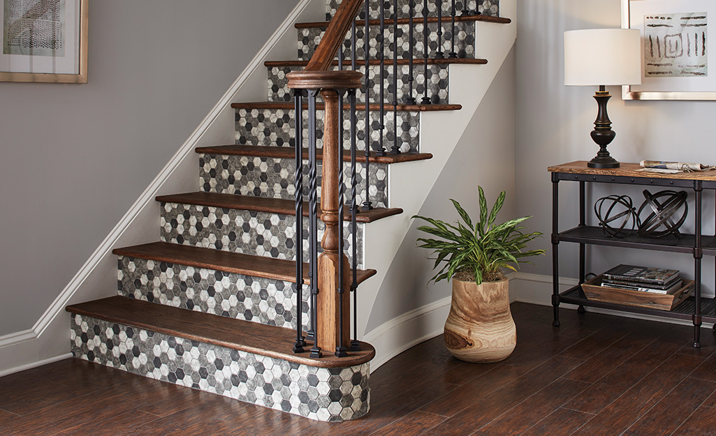 Staircase in entryway with tiled stairs.