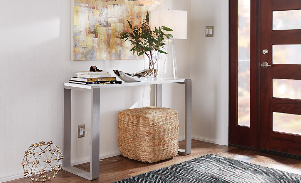 Small metal hallway table with a large storage basket.