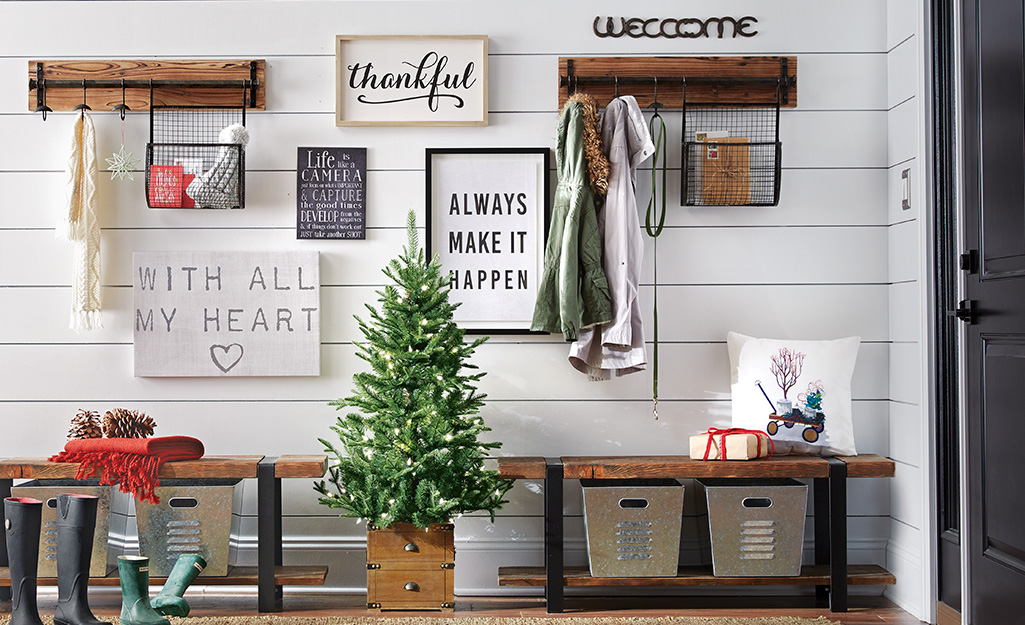 Entryway with a holiday tree and art.