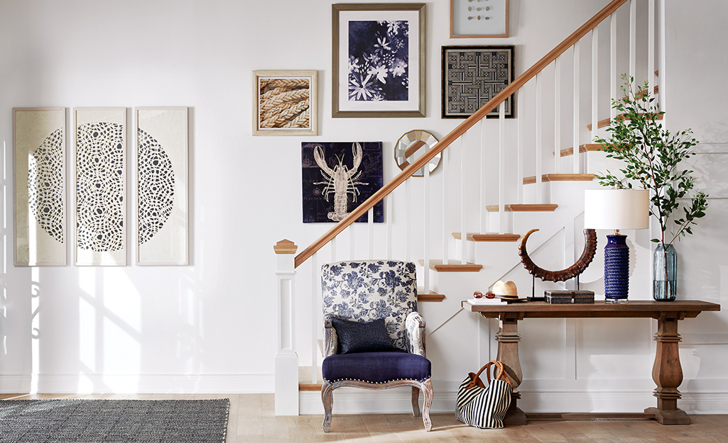 Entryway with console table in front of staircase.