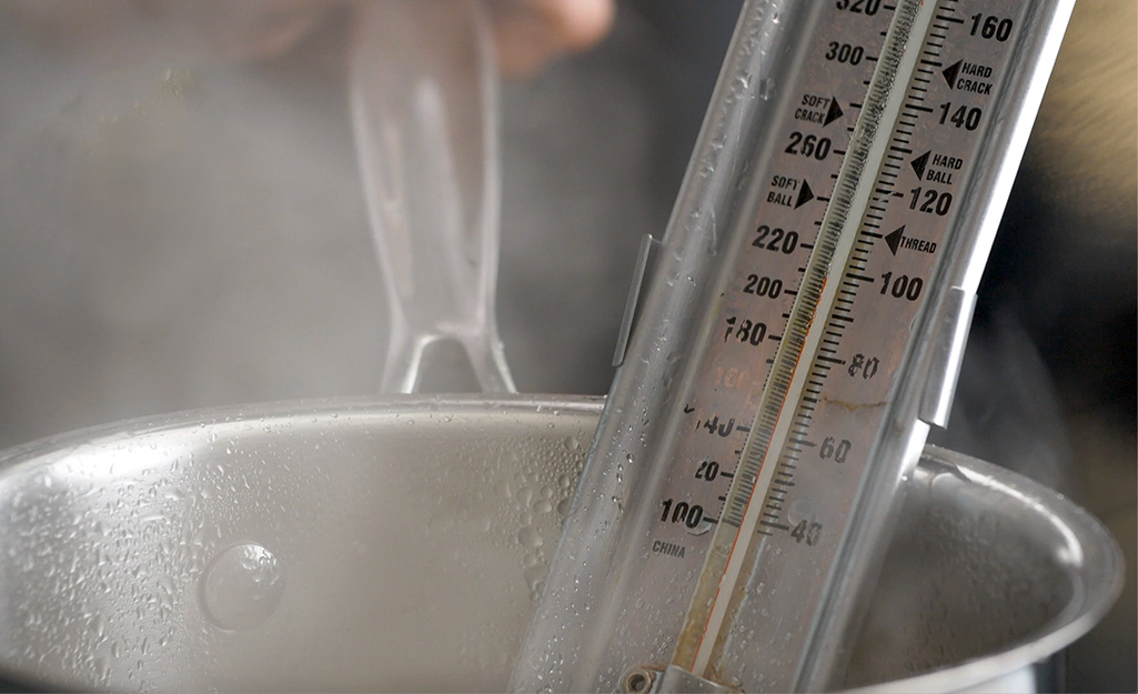 Silver sugar thermometer in a boiling pot