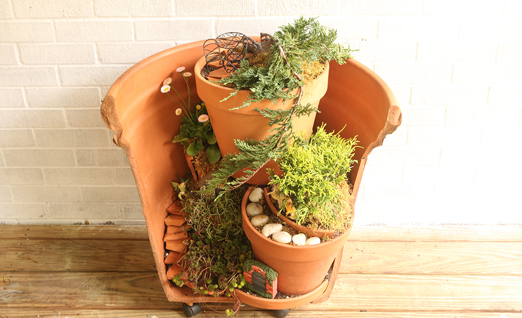 Three flowerpots combined to make a fairy garden.