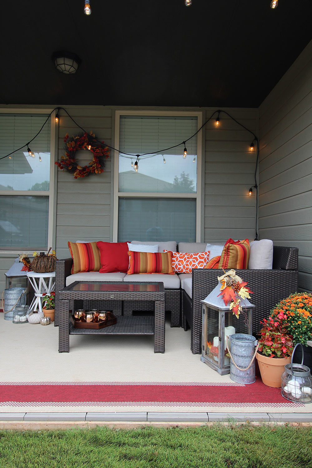 A set of string lights hangs over an outdoor patio sectional.