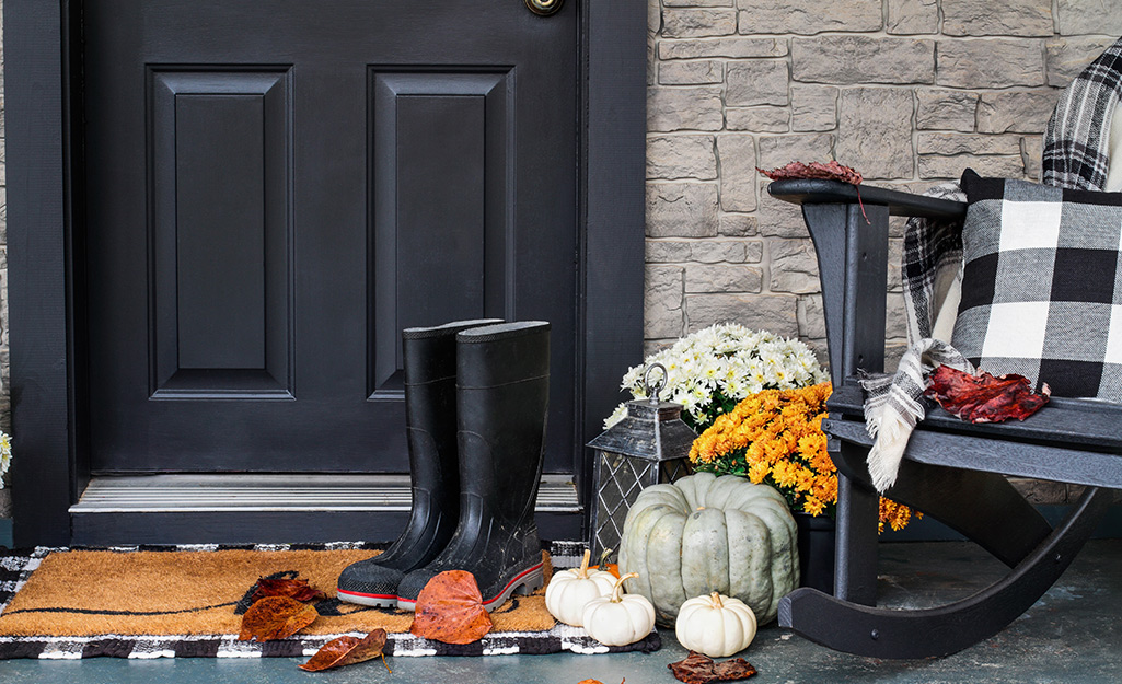 A freshly painted door and a decorated fall porch.