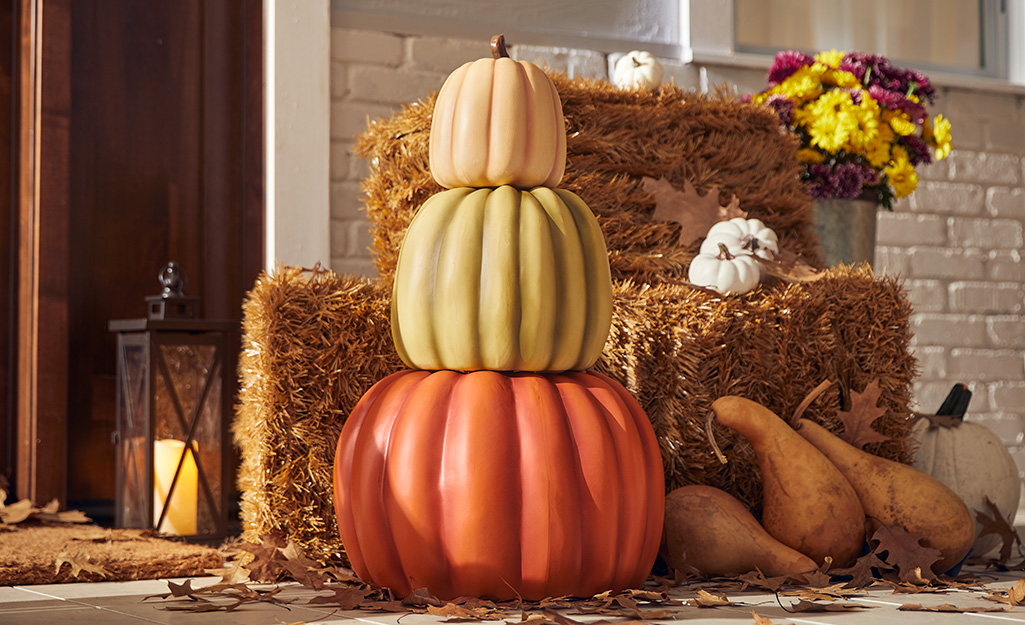 A fall porch decorated in a fall color scheme.