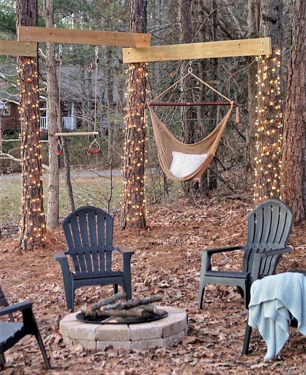 Chairs around the fire put and a hammock in the trees