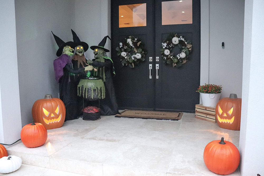 A front porch decorated with family friendly Halloween decor.