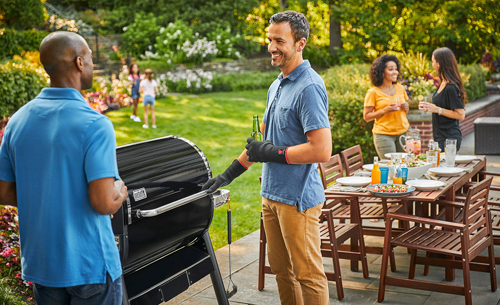 Father showing off his new gas grill.