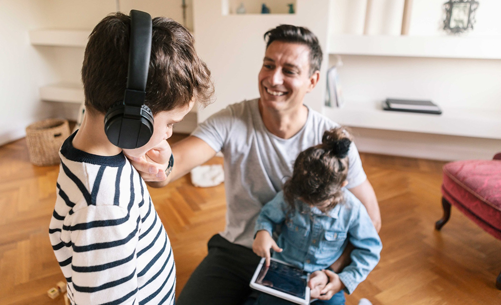 Dad and kids enjoying new tech toys.